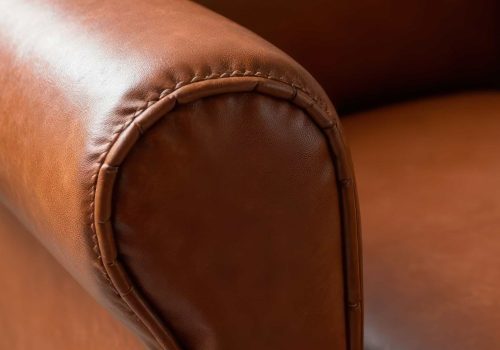modern-furniture-interior-design-craftsmanship-home-decor-closeup-leather-armchair-with-intricate-stitching-soft-texture-natural-light-min